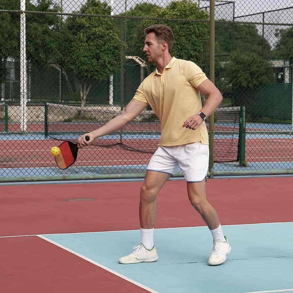 MAN PLAYING WITH ECHO WOOD PICKLEBALL PADDLE